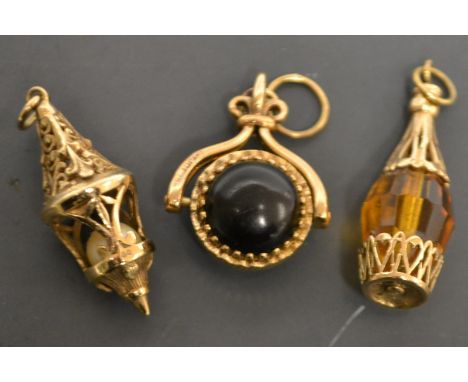 A 9ct gold and tigers eye swivel fob;  a 9ct gold and simulated pearl lantern charm;  another bottle, 15.8g gross (3)
