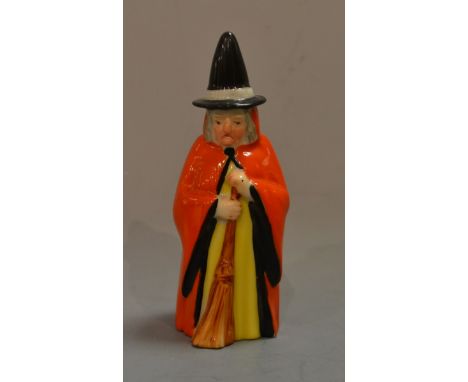 A Royal Worcester candle snuffer, Witch, with pointed hat, red cape and broom, 10cm high, printed crown and circle mark in pu