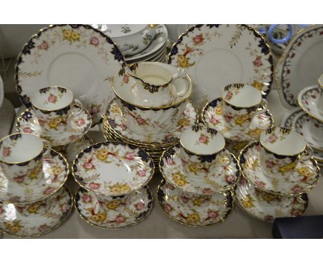 A Victorian floral tea service for twelve, one cup missing.