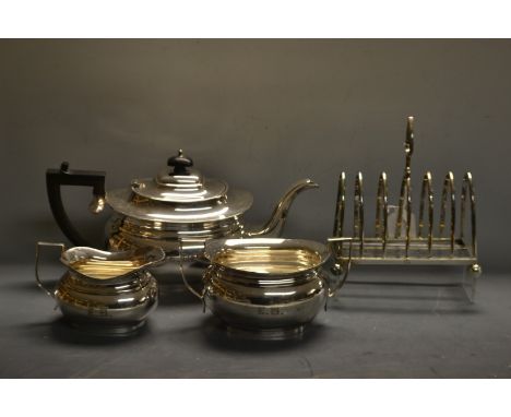 A Yeoman EPNS three piece boat shaped tea service; an EPNS seven bar toast rack (4)