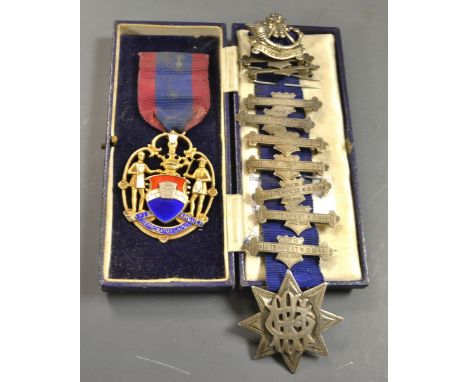 A silver gilt and enamel medal; attendance pins; badges