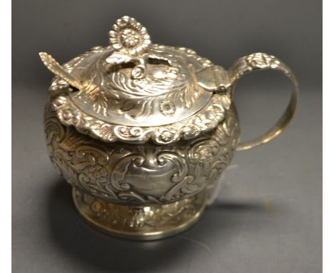 A George IV silver mustard, embossed overall with foliate scrolls, domed cover, flower finial, 8.5cm high, Edward Barnard,  L