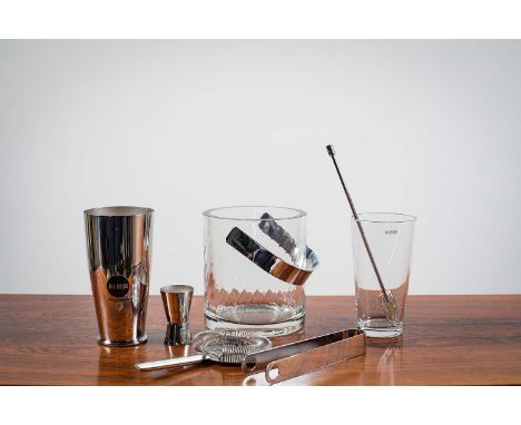 A COCKTAIL SHAKER SET by Ettori Sottsass for Alessi, comprising a two piece shaker, measure, bar strainer and stirrer (bearin