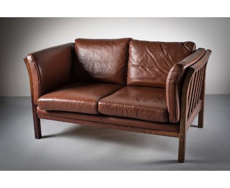  A ROSEWOOD FRAMED AND TANNED LEATHER UPHOLSTERED TWO SEAT SOFA EN SUITE, DANISH, with splayed slatted supports, on square le