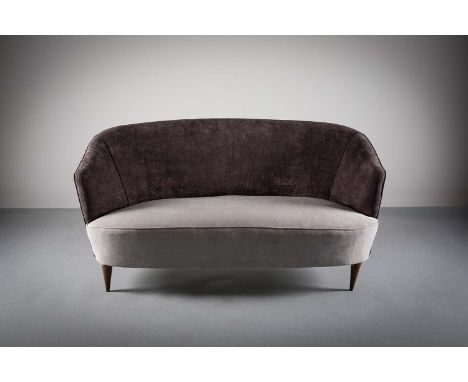 A SHAPED SOFA, Italian, 1960s, upholstered in grey fabric, 137 cm (w) x 70cm (d) x 72 cm (h).