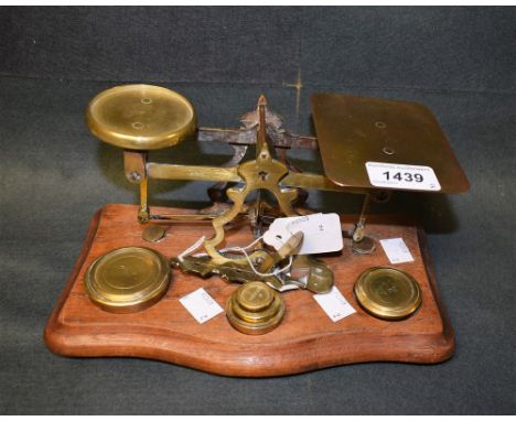 A set of postal scales, mahogany base, weights; a set of Bourn sovereign scales