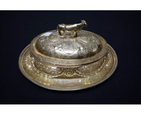 A silver plated and glass butter dish, sway design, naturalistically cast model of a cow to finial 