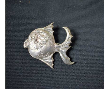 An unusual early/ mid 20th century abstract silver brooch, as a fish, incised and impressed scales, mouth and tail, unmarked 