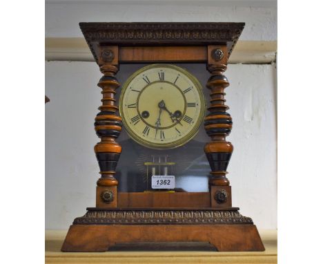 A Junghans bracket clock, carved acanthus leaf cornice, Roman numerals on cream dial flanked by turned wood columns, plinth b