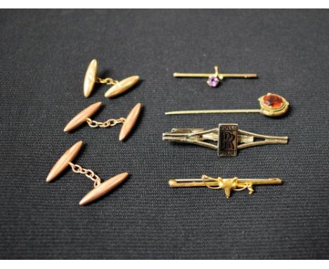 A pair of 9ct rose gold torpedo cuff links, 3g; a 9ct gold fox mask hunting pin brooch; a Rolls Royce metal tie clip; a 9ct g