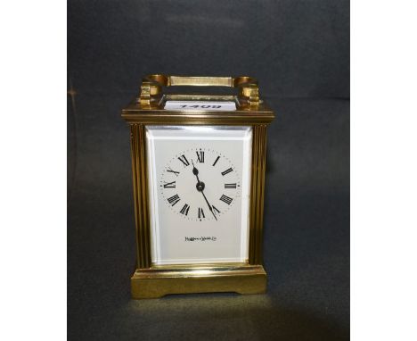 A Mappin & Webb brass carriage clock, bevelled glass panels, folding handle