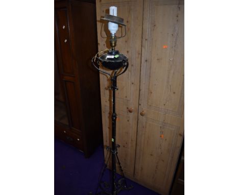 A wrought metal standard lamp, originally probably gas or oil and converted to electric, old wiring removed
