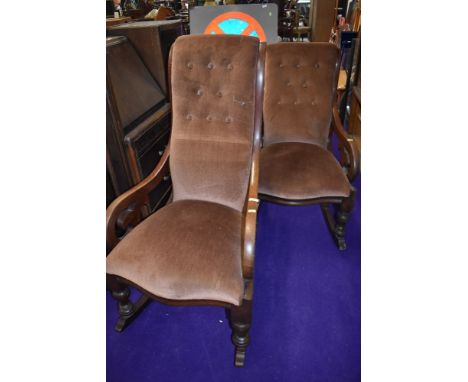 A ladies and gents pair of Victorian mahogany scroll frame rocking chairs having later dralon button back upholstery, seats a