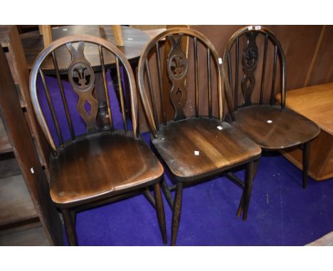Three vintage dark stained Ercol Fleur de lys style dining chairs