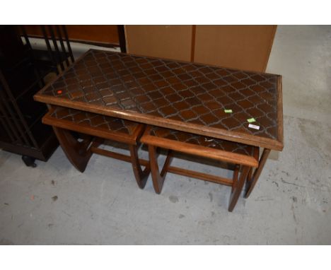 A vintage teak and tile top coffee table nest