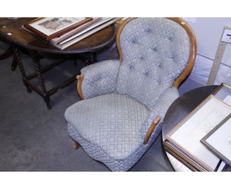 A Victorian walnut framed button back armchair