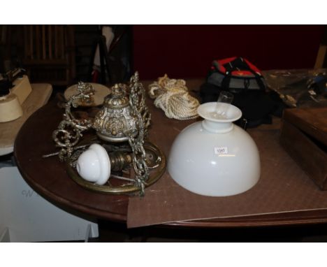 A brass and gilt metal hanging oil ceiling light with opaque glass shade 