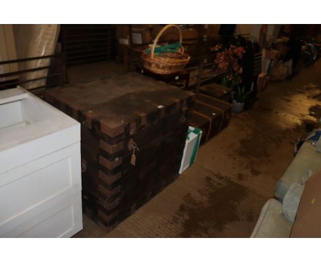 A large vintage wooden and metal bound trunk