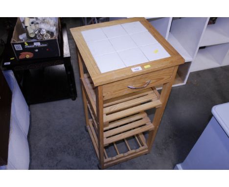 A pine tile top three tier table fitted single drawer