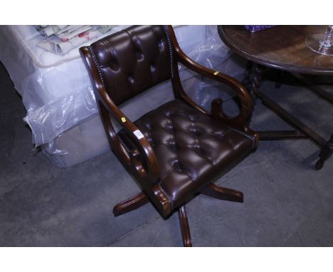 A mahogany framed and button upholstered swivel desk chair