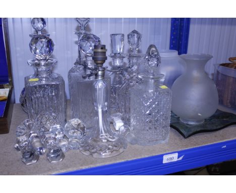 A collection of various cut and moulded glass decanters, stoppers, table lamp, shades etc. 