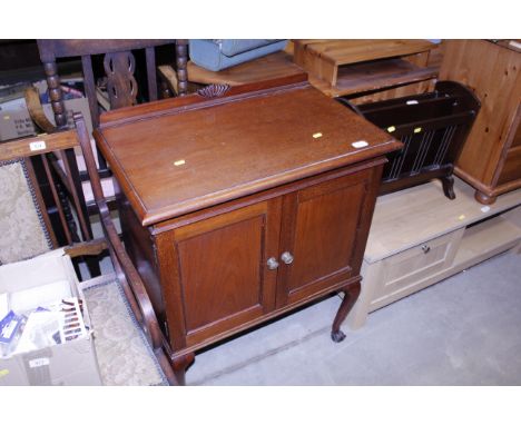 A mahogany two door folio cabinet on cabriole supports