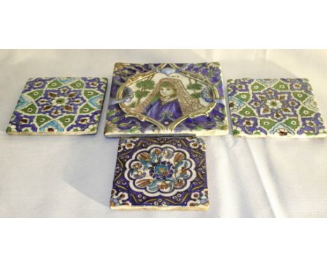 A Collection of Four 19th Century Persian Enamelled Tiles:
all painted in blue, green, white and brown.  To include: a larger