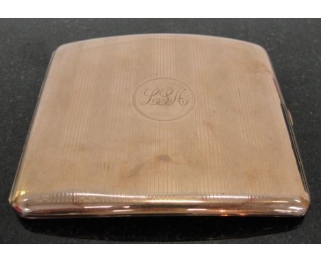 A 9ct Gold Cigarette Case:
of oblong form with engine turned engraving to both sides of case.    Circular cartouche to centre