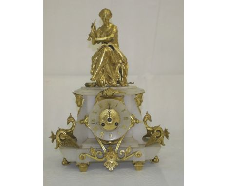 A 19th Century French Ormolu and Onyx Mantel Clock:
a seated lady playing pipes to the top, with Egyptian masks and griffins 