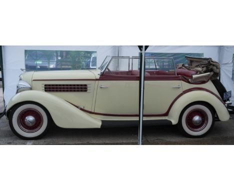 A 1935 Auburn 653 Phaeton convertible in tan, body in red  interior in red leather seats,this car is powered by its correct L