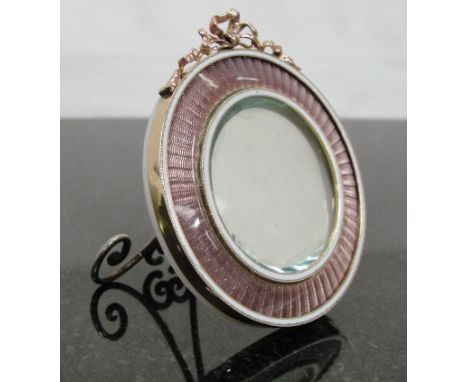 Carl Faberge (1846-1920): A Gold and Enamel Photograph Frame:
gold circular frame with guilloche enamels in white and lilac w