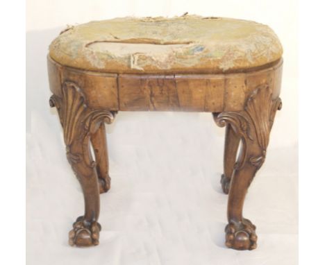 A George I Oval Walnut Stool:
with drop in tapestry seat, raised on elaborate shell and cabriole headed slender cabriole legs