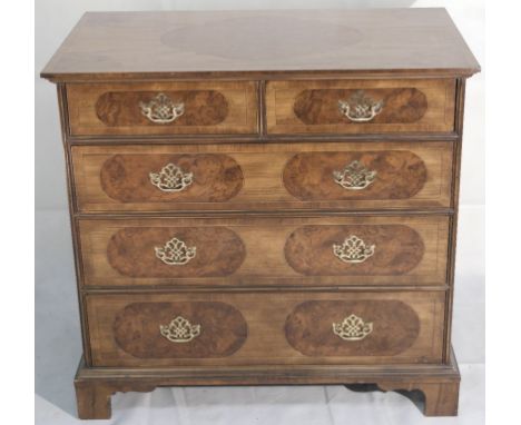 A 20th Century Georgian-Style Chest of Drawers:
a fine quality 20th century walnut chest of drawers in the Georgian style.  T