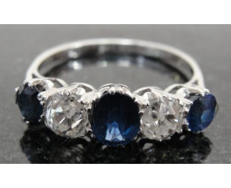 A Vintage Diamond and Sapphire Dress Ring:
an unhallmarked 18ct white gold claw set ring set with old cut diamonds and Burmes