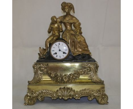 A 19th Century French Mantel Clock:
with woman and child to the top and with ornate garland to the front and shell and scroll