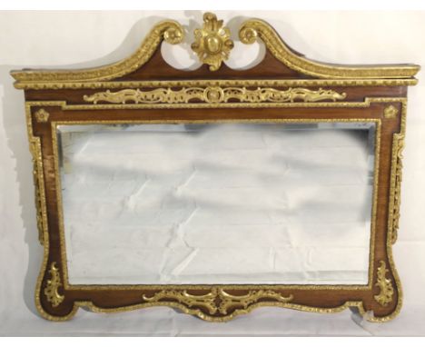 A Regency Mirror:
a Regency mirror in rosewood with gilt decoration surmounted with a broken arch pediment and central gilt m