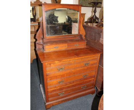 An Edwardian dressing chest with adjustable mirror, shelf and jewellery drawers, above three long drawers, on stepped bracket