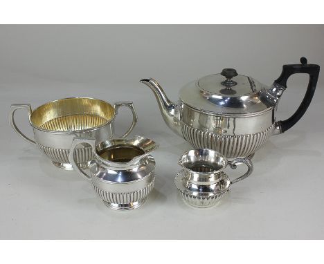 A silver plated three-piece tea set of half reeded form, together with a similar cream jug