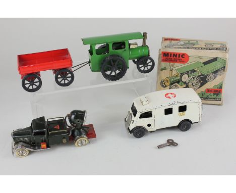 Three Tri-ang Minic clockwork model motor vehicles, comprising a traction engine and trailer, in red and green, with partial 