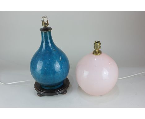 A turquoise crackle glaze pottery table lamp on hardwood base, together with a pale pink glass table lamp