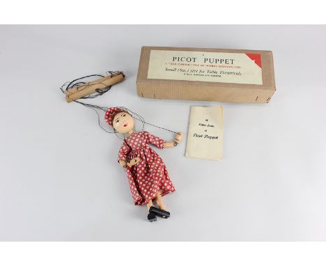 A Picot Puppet by Suprex (London) Ltd, of a woman in pink spotted dress, with original instructions, in original box