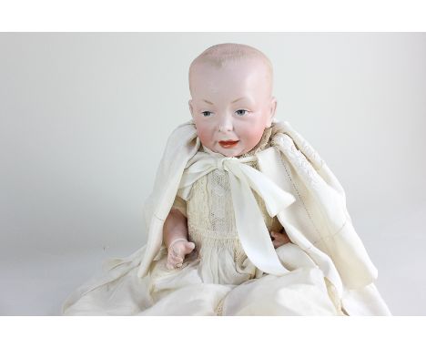 A Kammer &amp; Reinhardt 'Kaiser Baby' German bisque head doll with intaglio blue eyes, moulded open mouth and domed head mar
