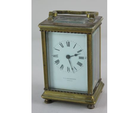 A brass cased carriage clock, the white enamel dial with Roman numerals, marked F.E. Rutherford Hawick, 12cm high, with key (