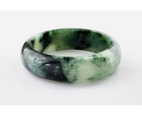 A contemporary jade bangle, of dark green and white marbled colouring and with a diameter of approximately 56mm.