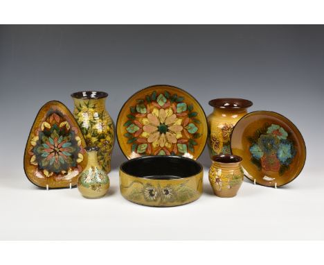A large collection of Guernsey Pottery, to include vases of varying forms, dishes, salt cellar, etc., all similarly decorated