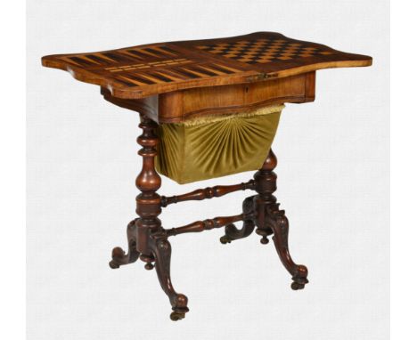 A Victorian burr walnut games and work table, the serpentine fold-over top swivelling to reveal boxwood and ebony backgammon,