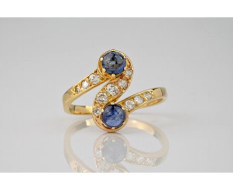 A French mid-century 18ct gold, cabochon sapphire and diamond twist ring, the ring centred by an S-scroll with two cabochon s