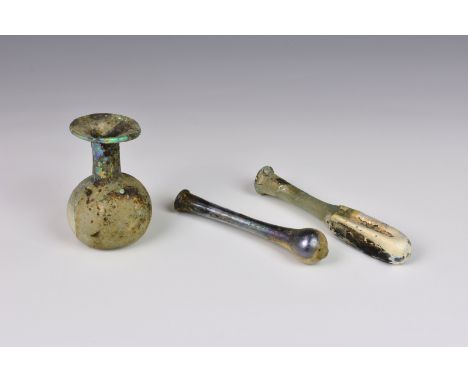 A small Roman iridescent glass unguentarium, 1st-2nd century AD, in highly iridescent clear glass, of drawn, elongated teardr