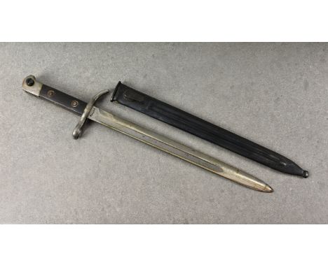 A c.1927 Finnish bayonet, with single edge fullered blade, wooden grip, having steel quillon and muzzle ring, marked FISKARS 