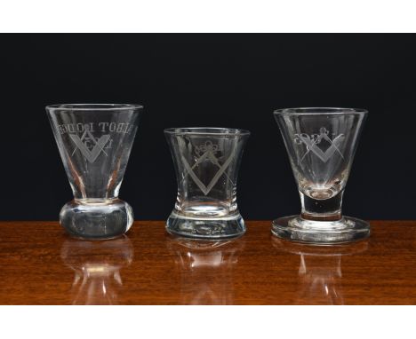 Three 19th century Masonic firing glasses, all with engraved square and compass motif, comprising a waisted tumbler style gla